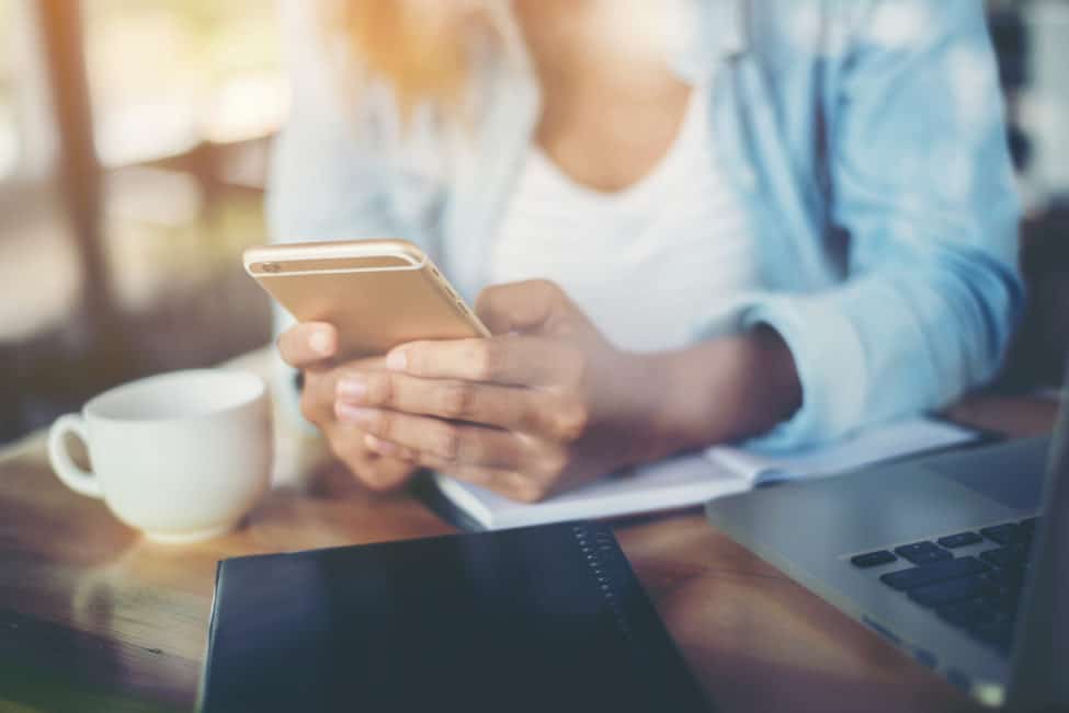 woman managing wordpress website with her mobile phone app